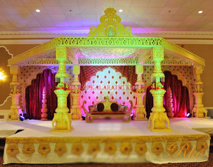 stage neck inn wedding mythological pillar mandap with squire arch and top arch with crystal strings finishing for lighting and bighting of mandap and stage in venue palace of wedding manda mandaps stage 