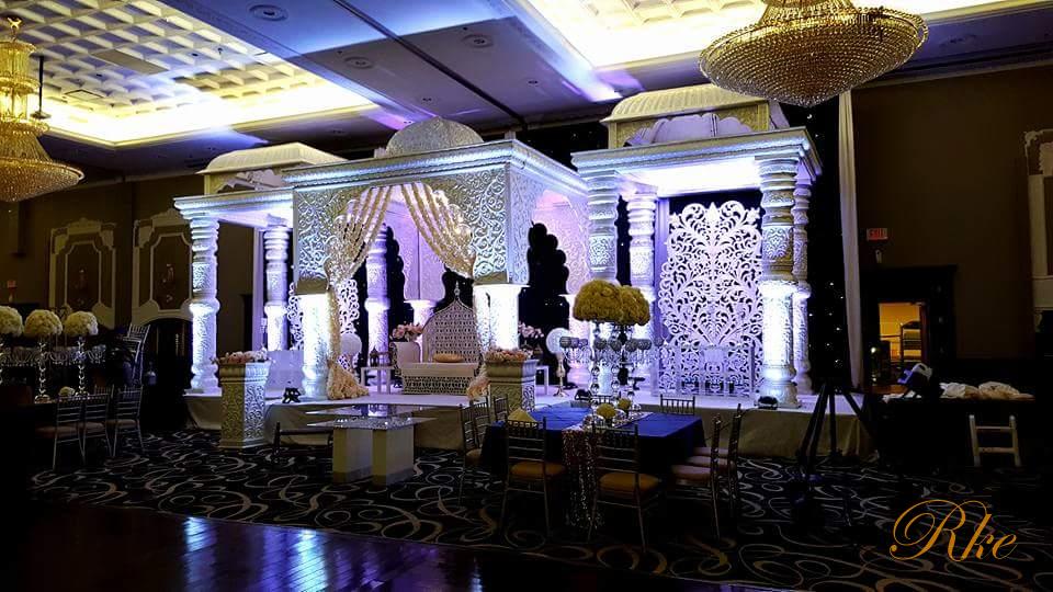 simple wedding stage with white pearl looks royal theme of wedding by side temple view and middle arch view of stage more than 16 feet height by pillar arch canopy dome in fiberglass easily setup mandap stage by 6 to 8 people in banquet hall  